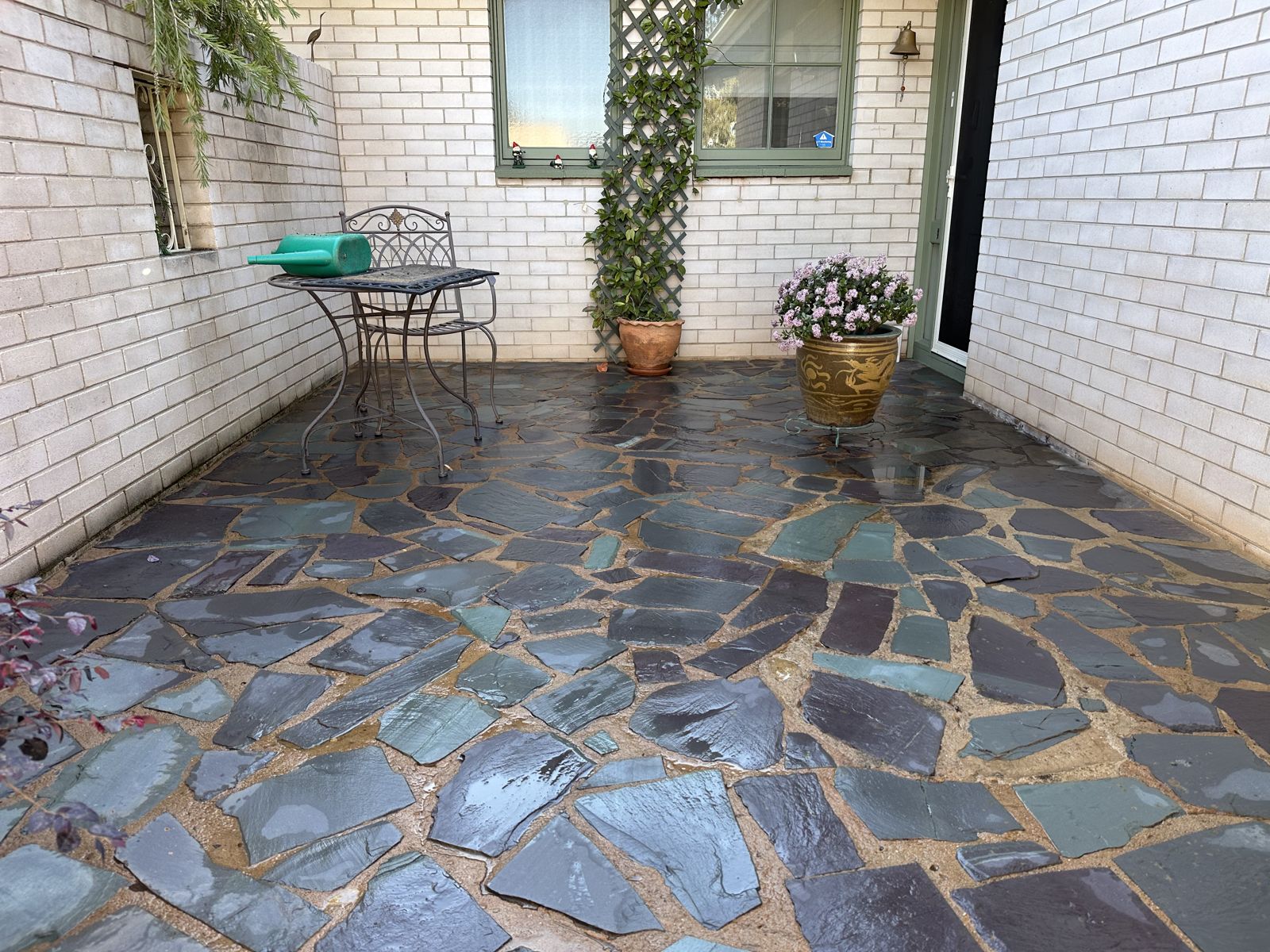 Tiled patio deck cleaned to remove moss and algae