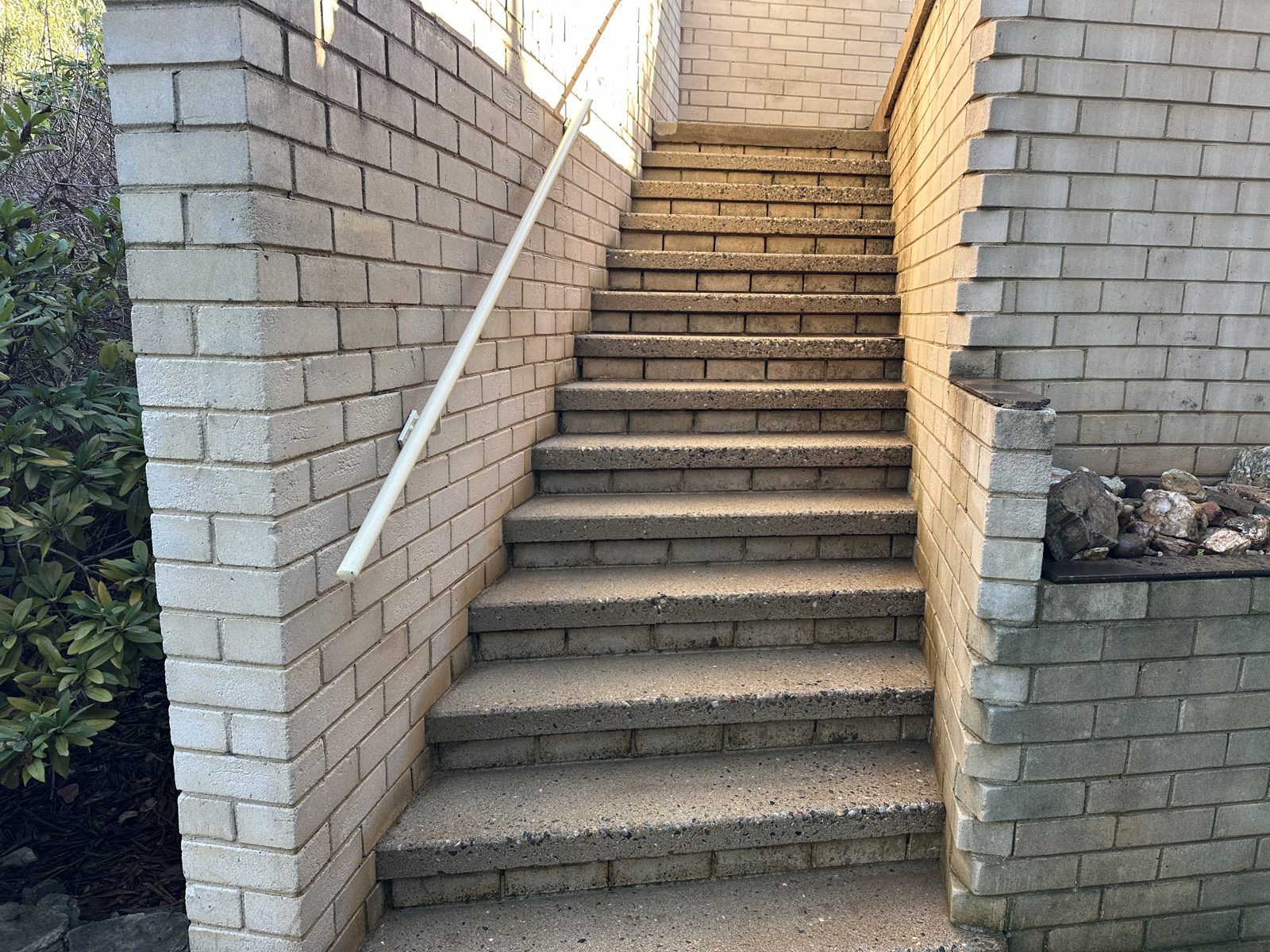 Concrete steps and brick walls after pressure washing and chemical treatment