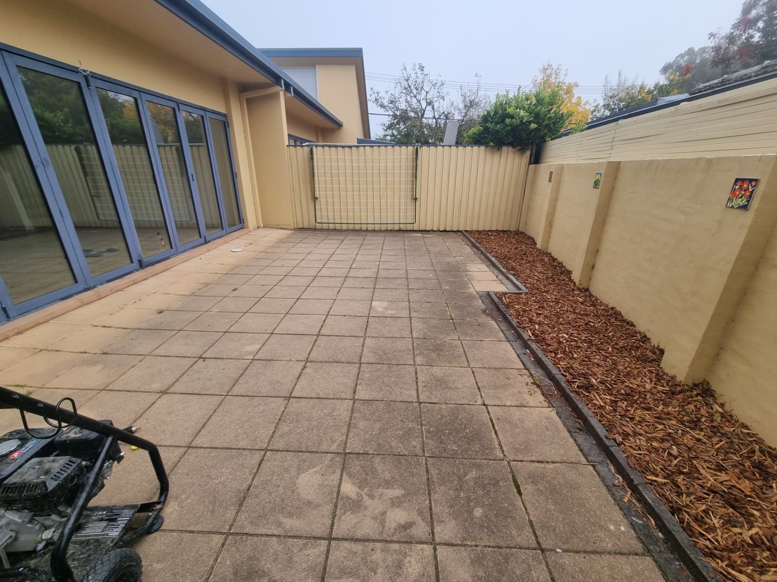 Paved courtyard being pressure cleaned at an inner south Canberra home